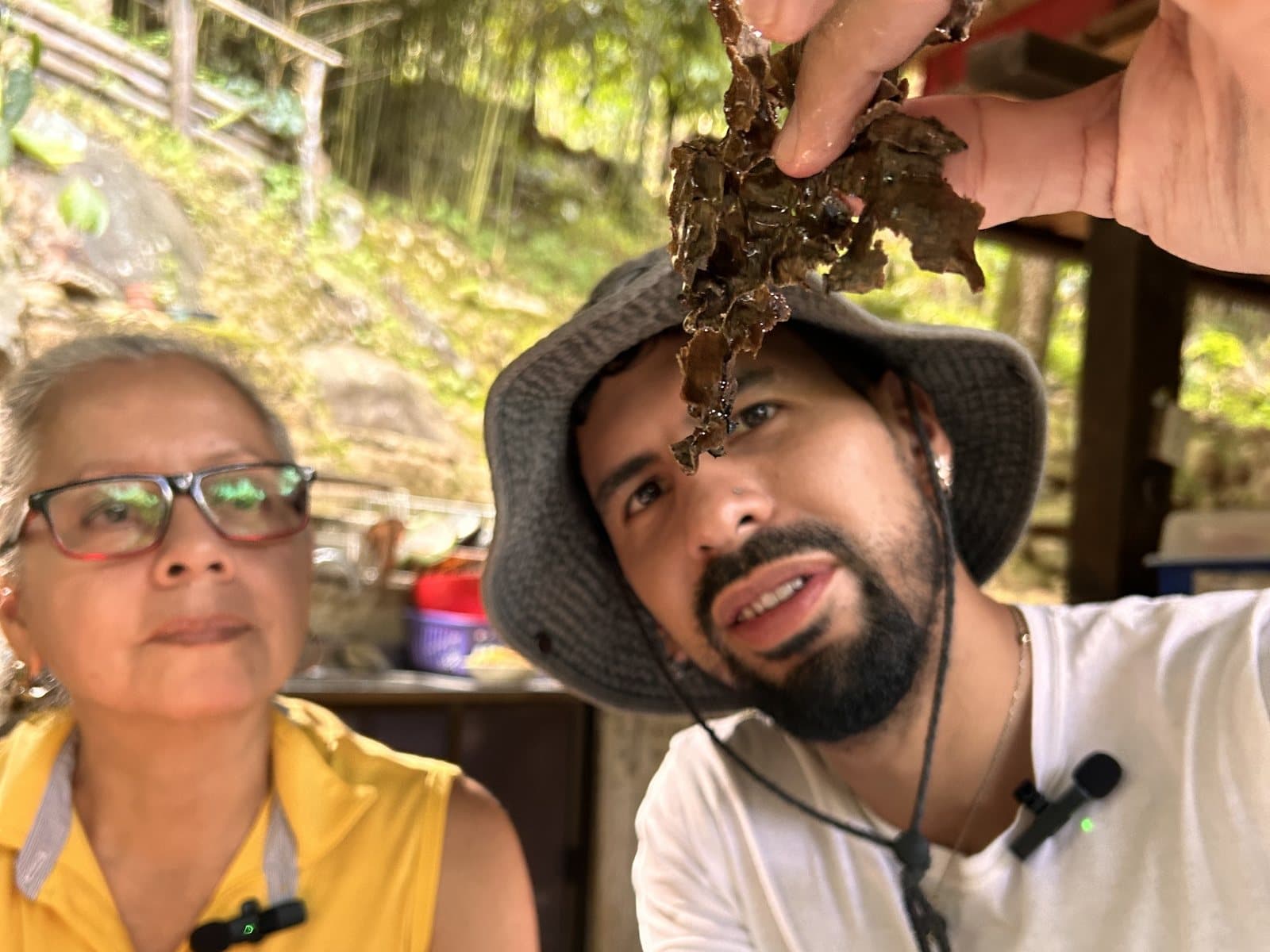 Chris and an elder holding up harvested sea moss
