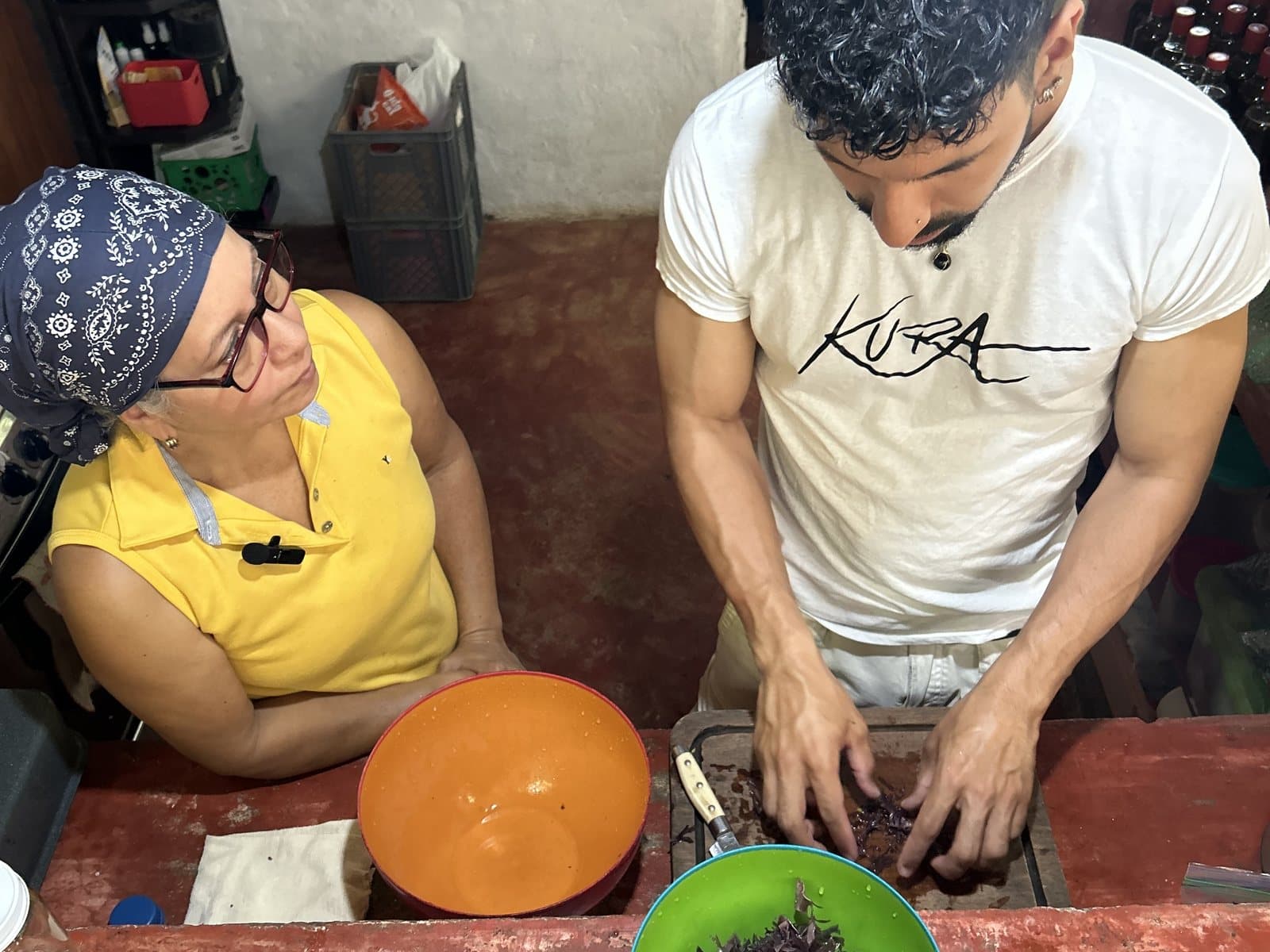 Chris sorting purple sea moss in a kitchen